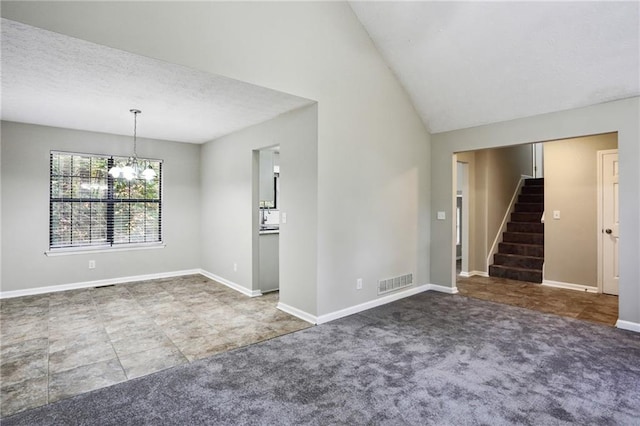 unfurnished room featuring vaulted ceiling, dark colored carpet, and a textured ceiling