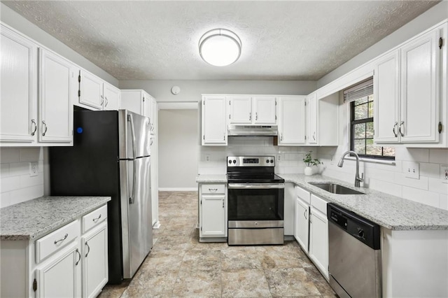 kitchen with white cabinetry, sink, stainless steel appliances, and light stone counters