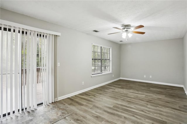 empty room with ceiling fan and hardwood / wood-style flooring