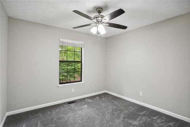 carpeted empty room featuring a textured ceiling and ceiling fan