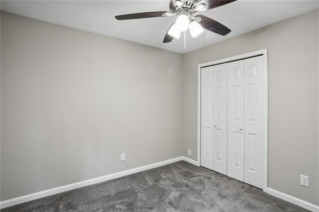 unfurnished bedroom featuring a closet, dark carpet, and ceiling fan