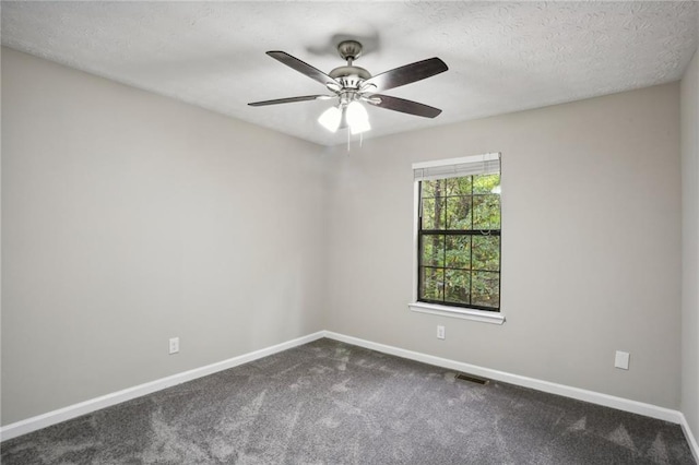 empty room with carpet flooring, ceiling fan, and a textured ceiling