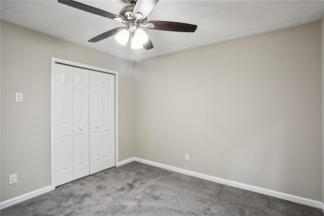 unfurnished bedroom with ceiling fan, a closet, and carpet floors