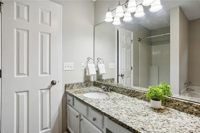 bathroom with vanity and shower / washtub combination