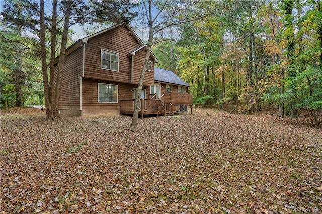 rear view of house featuring a deck