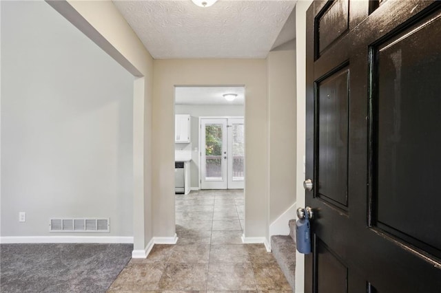 entrance foyer featuring a textured ceiling