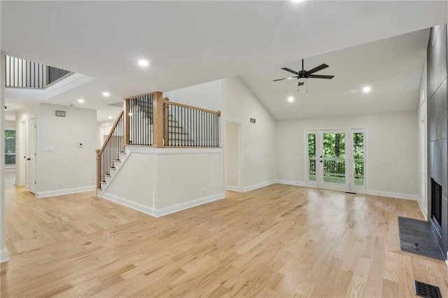 545 Woodman Pl, Roswell, GA 30076 - unfurnished living room with stairway, light wood-style floors, high vaulted ceiling, a ceiling fan, and recessed lighting