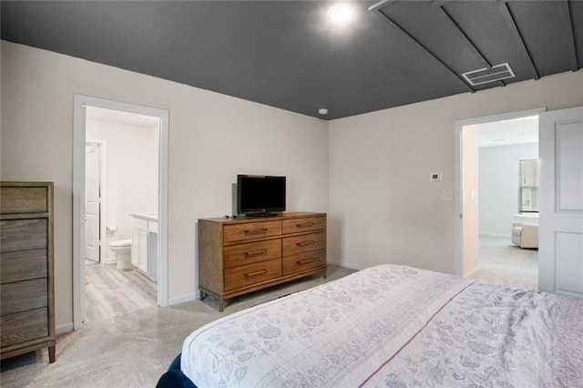 217 Limestone Cir, Conyers, GA 30013 - bedroom featuring light carpet, ensuite bath, and baseboards