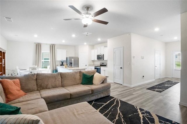 217 Limestone Cir, Conyers, GA 30013 - living room with light wood-type flooring, a ceiling fan, recessed lighting, and baseboards