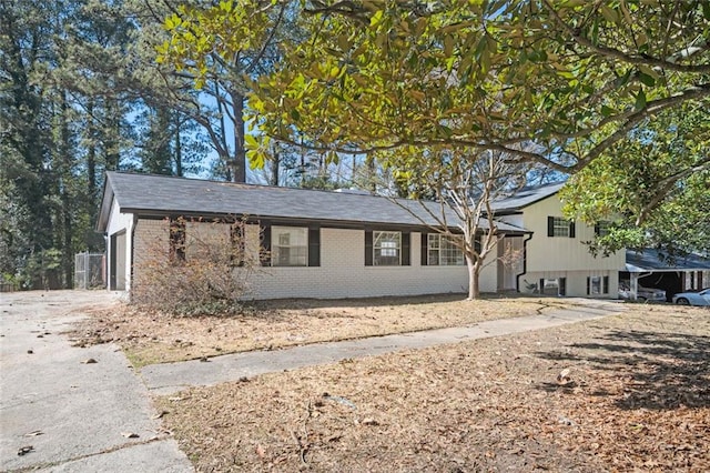 tri-level home with brick siding and driveway