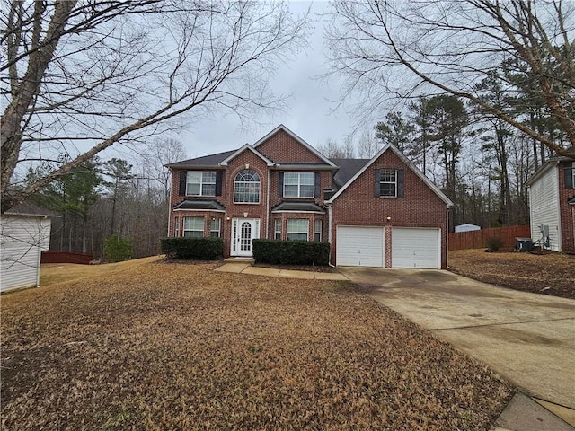 view of front property with central AC and a garage