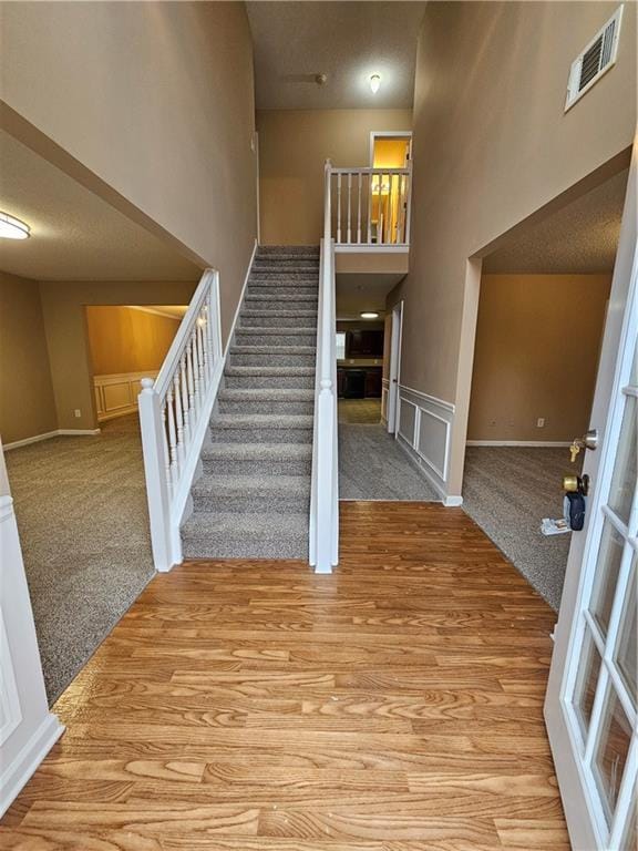 entryway with a high ceiling and light wood-type flooring