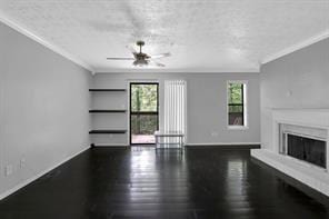 unfurnished living room featuring crown molding, ceiling fan, and dark hardwood / wood-style flooring