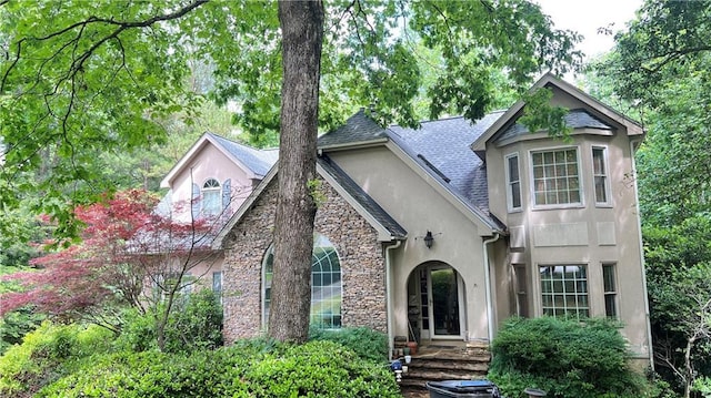5357 Steeple Chase, Douglasville, GA 30135 - view of front of home with stucco siding, a shingled roof, and stone siding