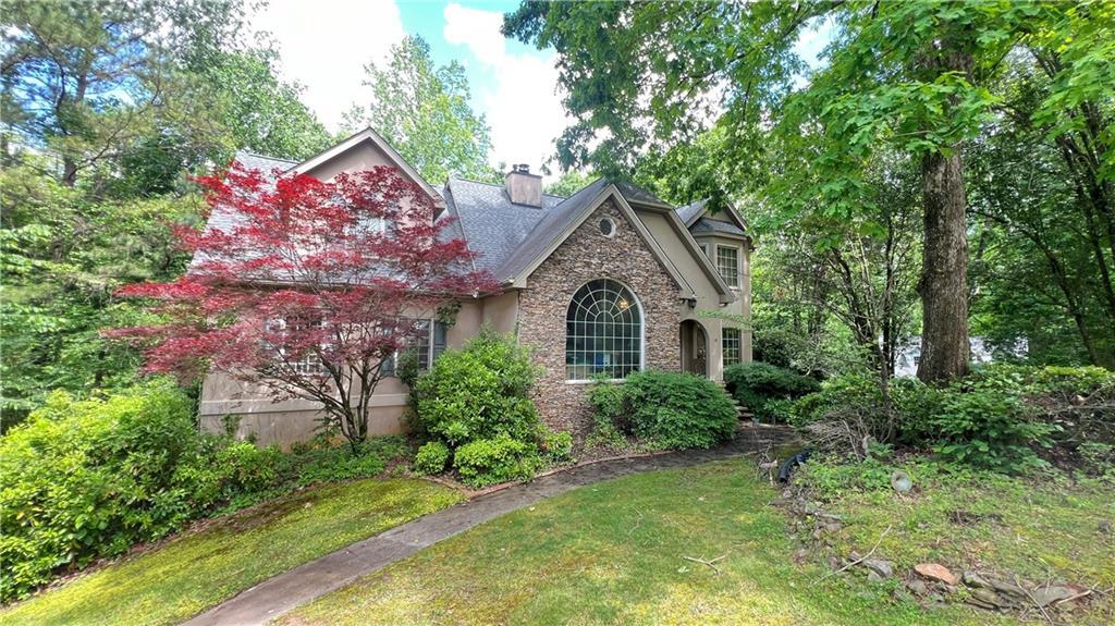 5357 Steeple Chase, Douglasville, GA 30135 - view of front of property with stone siding, a chimney, and a front yard