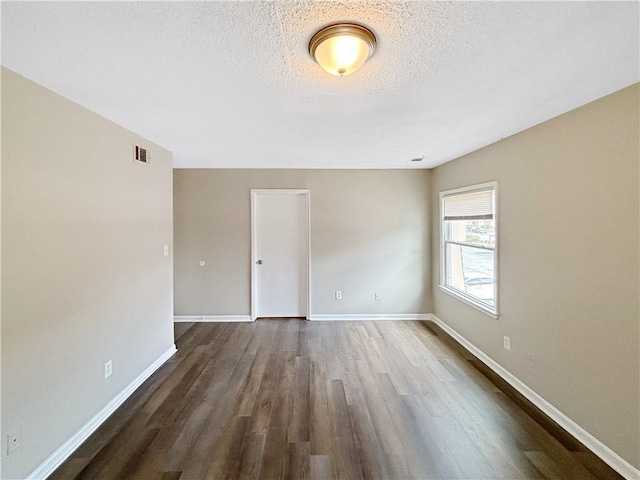 2992 Parc Lorraine, Lithonia, GA 30038 - unfurnished room with dark wood-style flooring and a textured ceiling