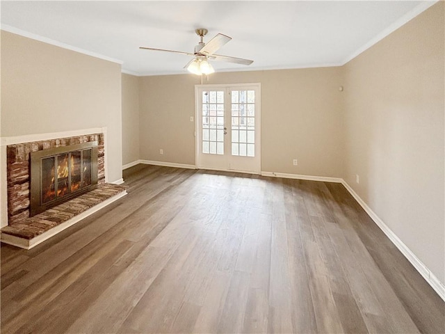 2992 Parc Lorraine, Lithonia, GA 30038 - unfurnished living room with ceiling fan, crown molding, wood finished floors, a fireplace, and french doors