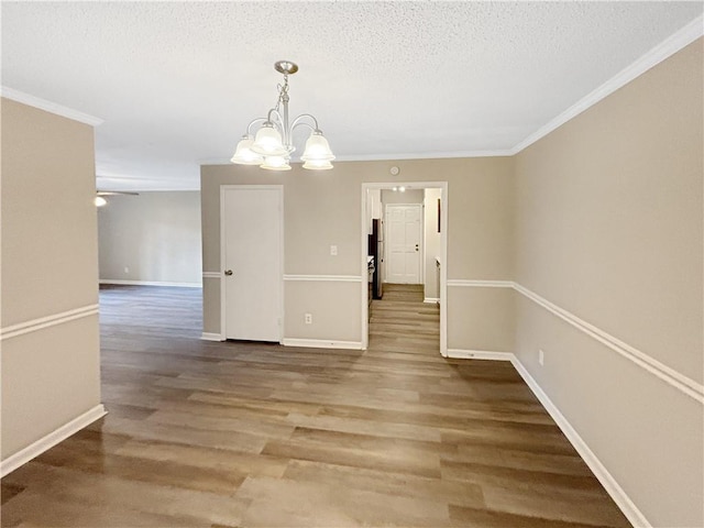 2992 Parc Lorraine, Lithonia, GA 30038 - unfurnished dining area featuring ornamental molding, a textured ceiling, a chandelier, and wood finished floors