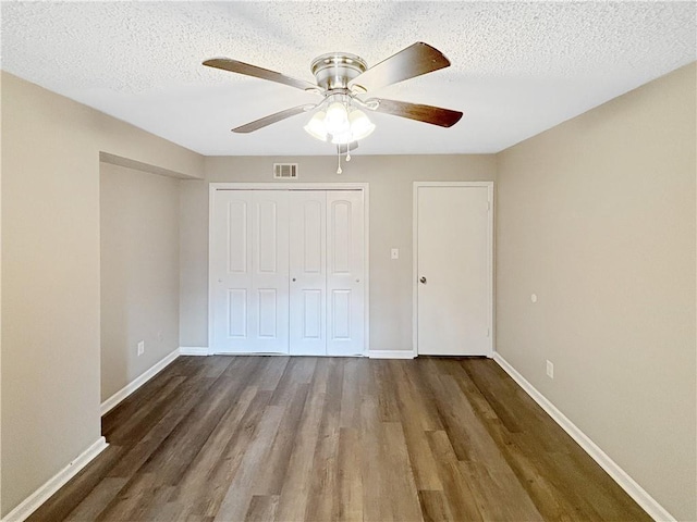 2992 Parc Lorraine, Lithonia, GA 30038 - unfurnished bedroom featuring wood finished floors, a closet, a ceiling fan, and a textured ceiling