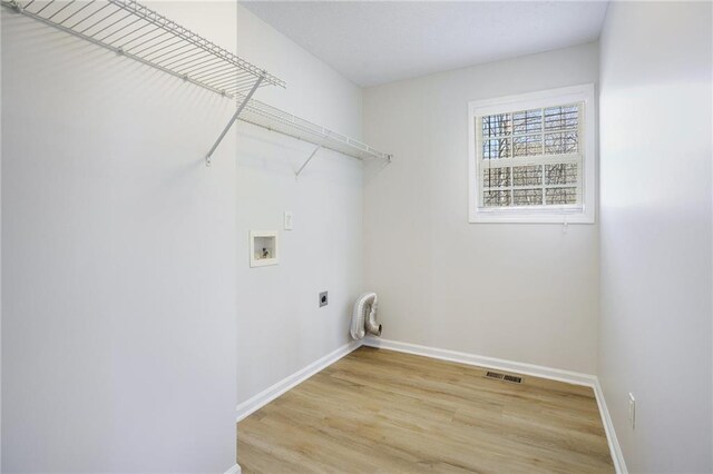 washroom featuring light wood-type flooring, baseboards, electric dryer hookup, laundry area, and washer hookup