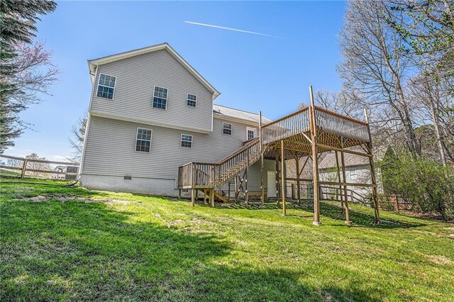 back of house featuring stairs, a wooden deck, and a yard