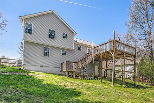 back of property with crawl space, stairway, a yard, and a wooden deck
