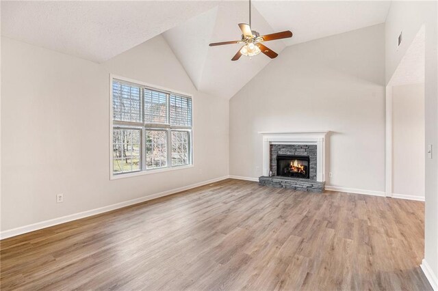 unfurnished living room with a ceiling fan, baseboards, and wood finished floors