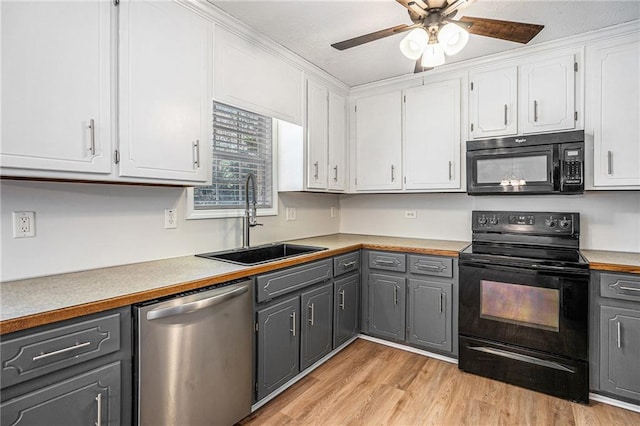 kitchen featuring white cabinetry, gray cabinets, a sink, and black appliances