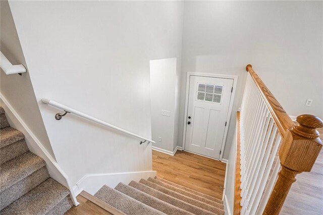 stairway featuring baseboards and wood finished floors