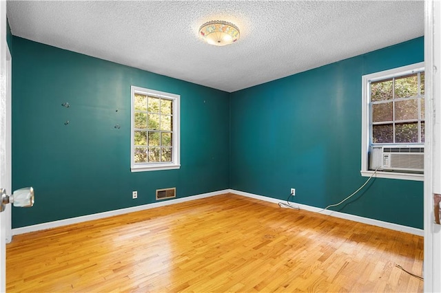 300 S Dale Ave, Calhoun, GA 30701 - empty room with wood finished floors and a textured ceiling