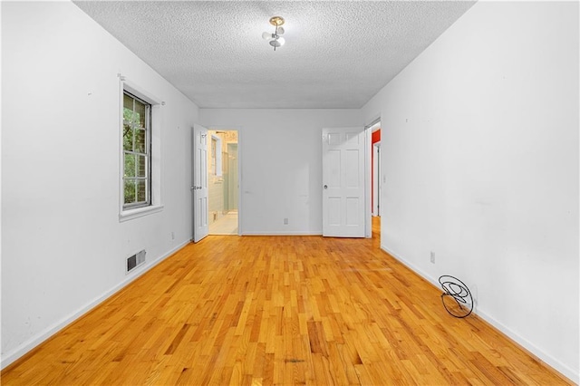 300 S Dale Ave, Calhoun, GA 30701 - empty room with a textured ceiling and light wood-style flooring