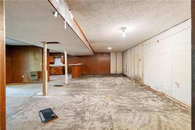 300 S Dale Ave, Calhoun, GA 30701 - finished basement with wooden walls, heating unit, and a textured ceiling
