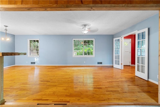 300 S Dale Ave, Calhoun, GA 30701 - spare room with light wood-type flooring, a textured ceiling, plenty of natural light, french doors, and a ceiling fan