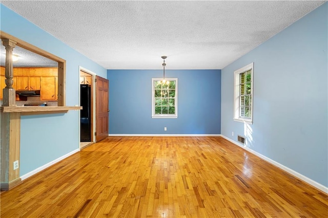 300 S Dale Ave, Calhoun, GA 30701 - unfurnished dining area featuring a textured ceiling and light wood-style floors