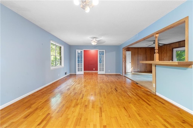 300 S Dale Ave, Calhoun, GA 30701 - unfurnished living room with wood finished floors, ceiling fan, and wood walls