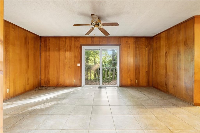 300 S Dale Ave, Calhoun, GA 30701 - spare room with wooden walls, ceiling fan, a textured ceiling, and light tile patterned flooring