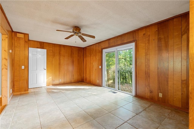 300 S Dale Ave, Calhoun, GA 30701 - spare room featuring wooden walls, a ceiling fan, a textured ceiling, and light tile patterned floors