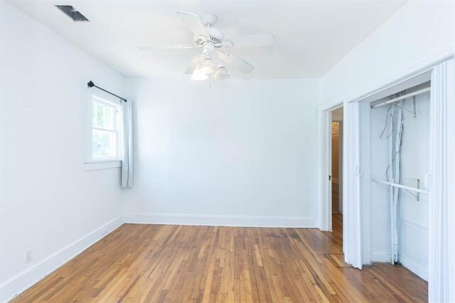 unfurnished bedroom featuring a closet, ceiling fan, and hardwood / wood-style floors