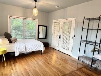 bedroom featuring hardwood / wood-style flooring and access to exterior