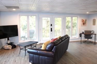 living room featuring wood-type flooring, french doors, and a wealth of natural light