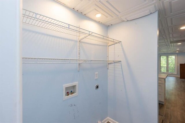 clothes washing area featuring hookup for an electric dryer, hardwood / wood-style floors, and washer hookup