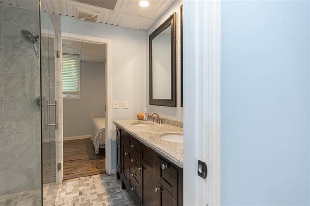 bathroom with vanity, hardwood / wood-style flooring, and a shower with door