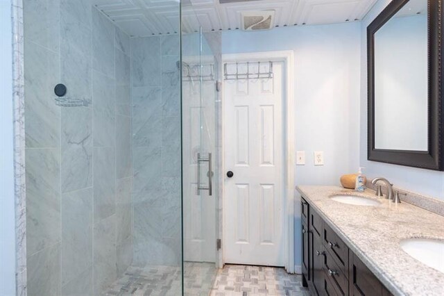 bathroom featuring vanity and tiled shower