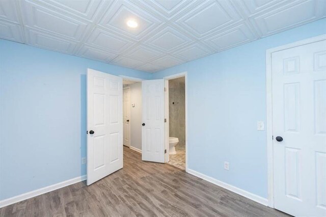 unfurnished bedroom with hardwood / wood-style floors