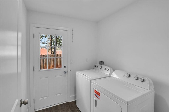 laundry area with dark hardwood / wood-style floors and washer and dryer