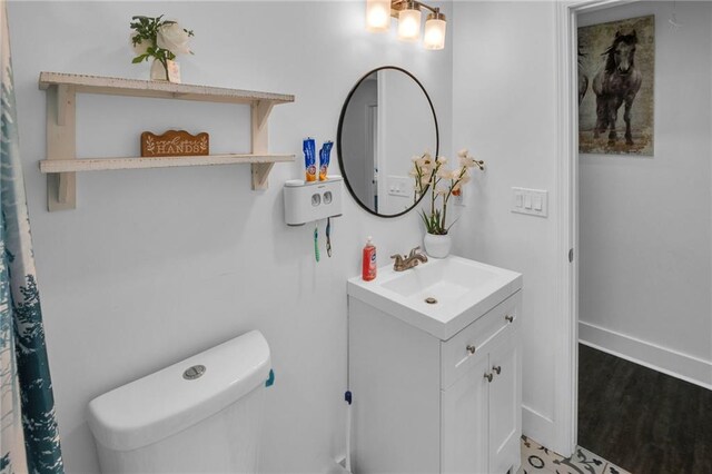 bathroom featuring hardwood / wood-style flooring, vanity, and toilet