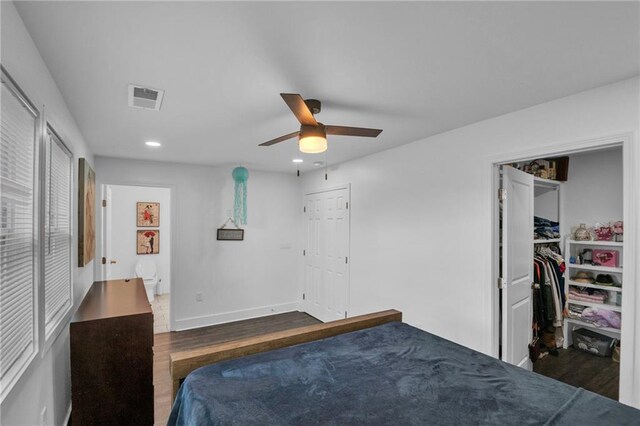 bedroom with ceiling fan, connected bathroom, and dark hardwood / wood-style floors