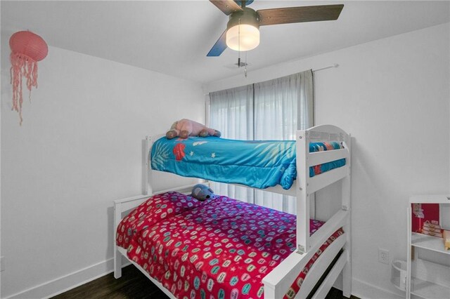 bedroom with ceiling fan and dark hardwood / wood-style flooring