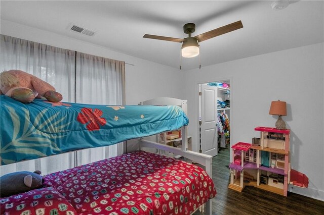 bedroom featuring ceiling fan, a closet, and dark hardwood / wood-style floors