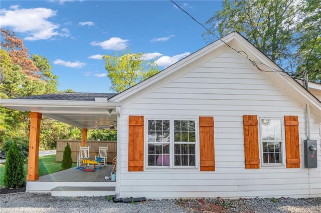 view of side of home with a wooden deck